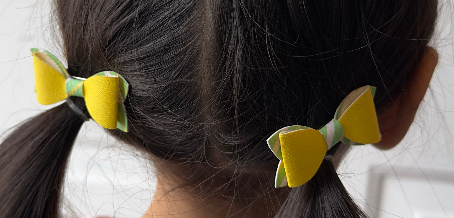 Yellow on green, yellow, and white striped 2pcs mini bows