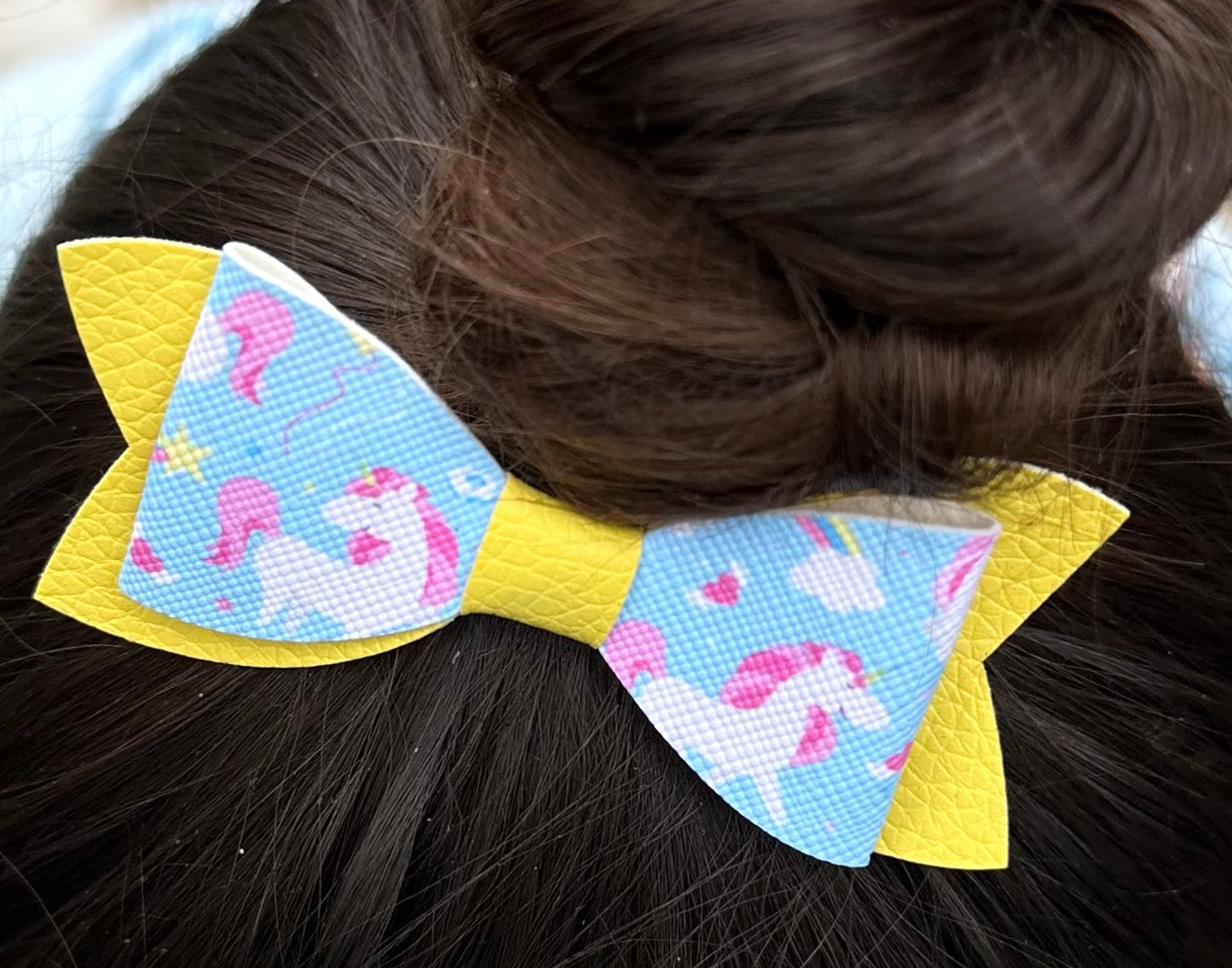 Unicorns on blue and yellow bow