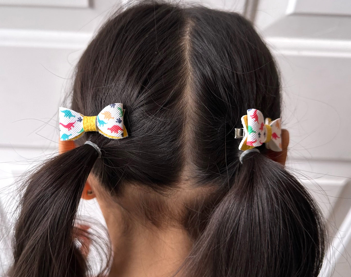 Multicolored dinosaur on yellow 2pcs mini bows