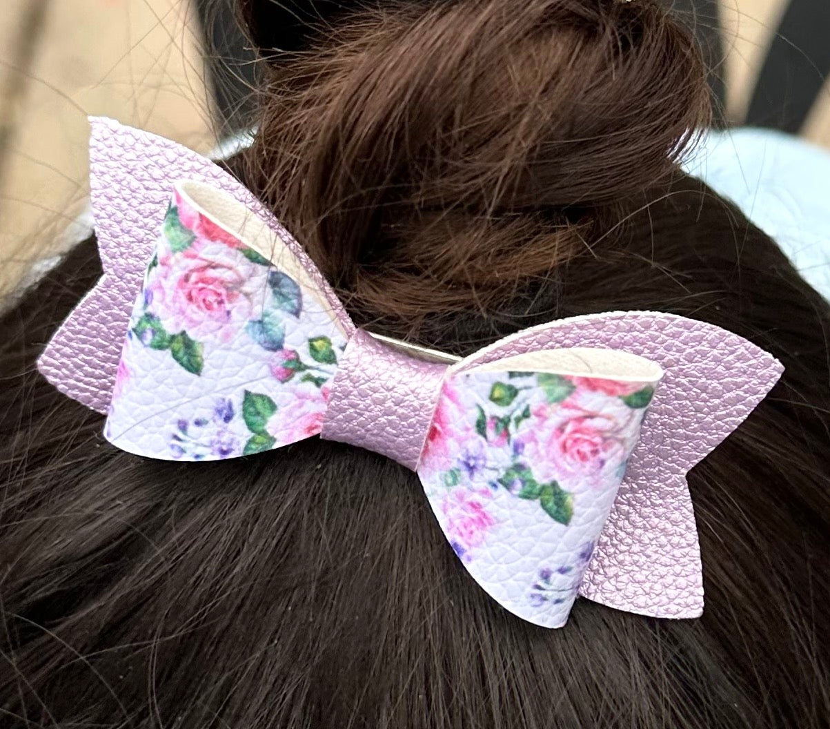 Purple roses on metallic bow