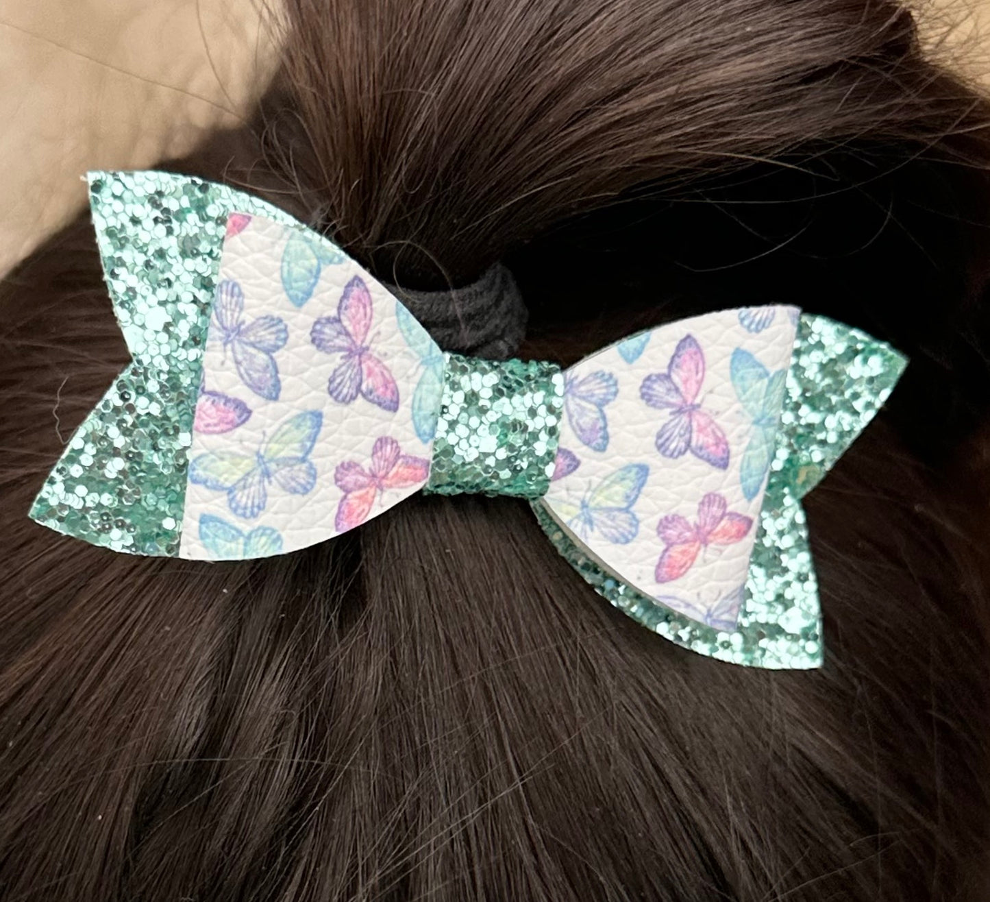 Pastel butterflies on green glitter bow